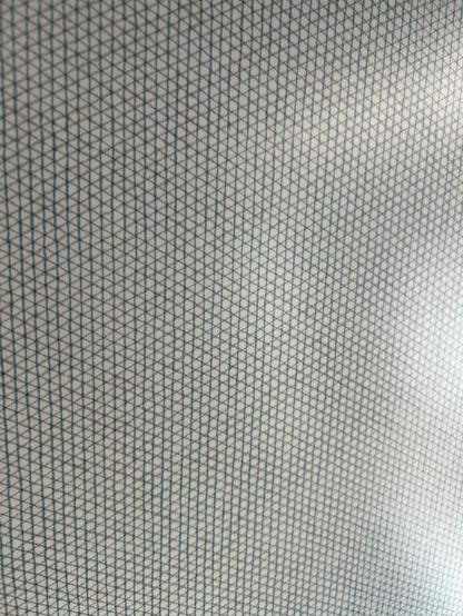 Closeup of a grey on white crosshatch-style pattern