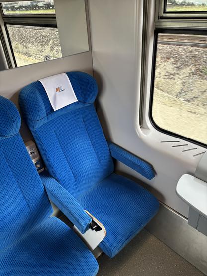 Comfortable seat upholstered in blue.