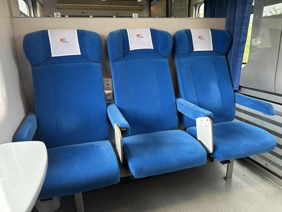 Three comfortable seats upholstered in blue.