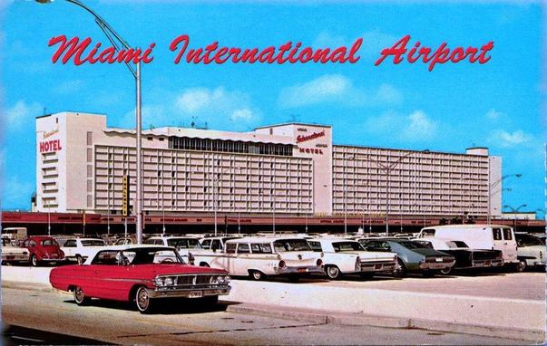 In the forground is a red car, center is the hotel, and on top is the text "Miami International Airport"