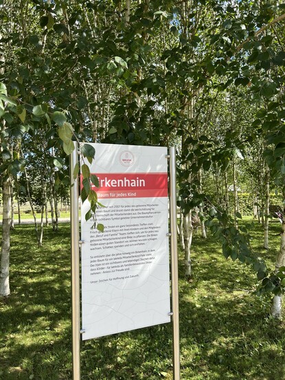 Corporate sign at Weleda explaining that a birch tree is planted for every child born to a co-worker