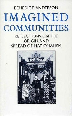The cover of Benedict Anderson's Imagined Communities. It's a spare cover, with the author, title and subtitle across the top on a white bacground, and a small photograph below them. The photograph is a formal still of three men posing in front of some kind of crest. The one in the middle is sitting down, with the two on either side standing up. The one on the right has his hand on the shoulder of the seated man.