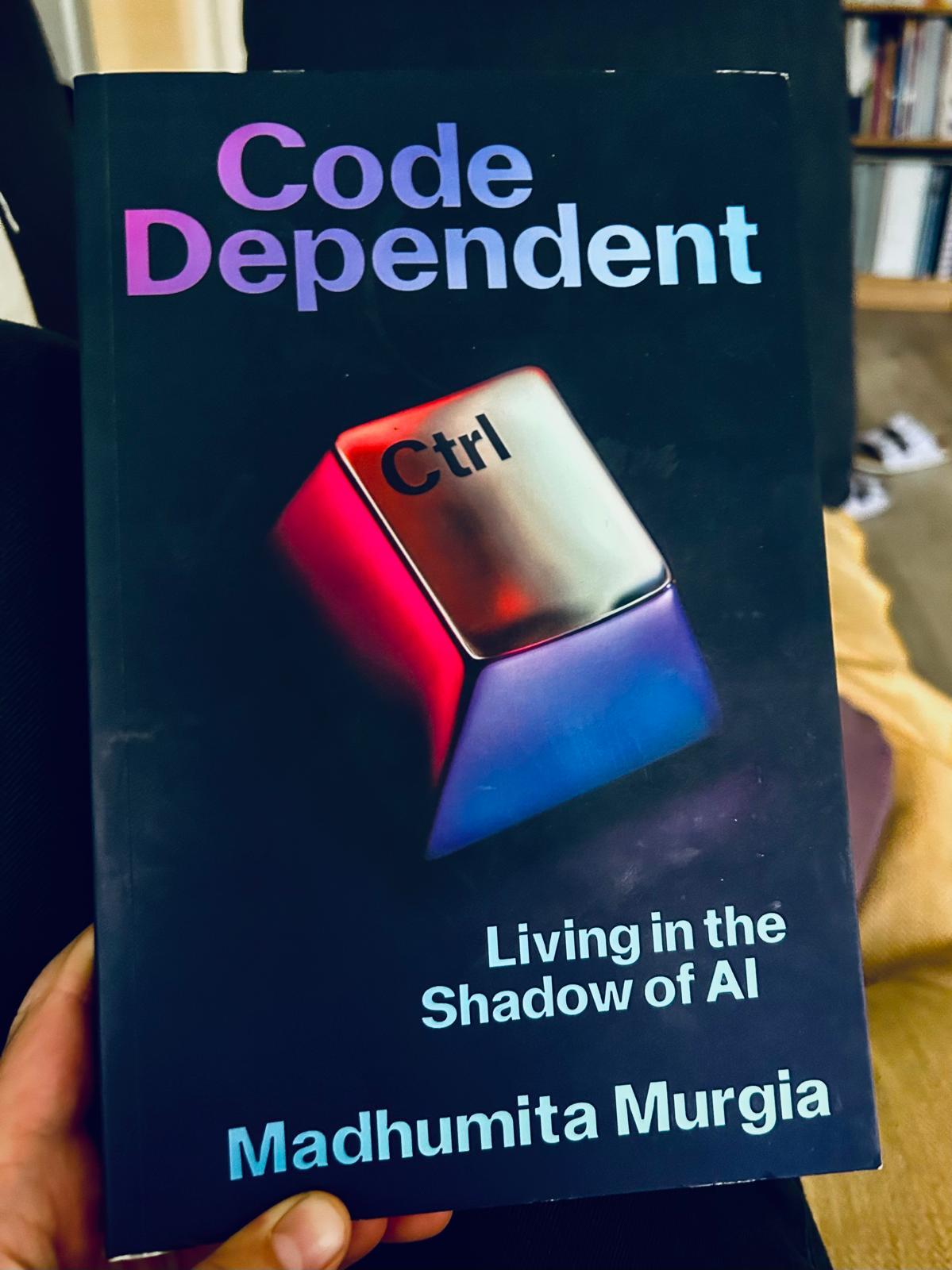 A photo of a book.
Title: Code Dependent - Living in the Shadow of AI
Author: Madhumita Murgia
On the cover is a chrome "Ctrl" key.
The colour scheme is blue-red-violet