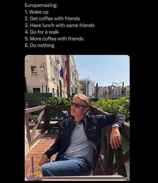 Europemaxxing meme featuring Mads Mikkelsen lounging in the sunshine at a terrace. List of items on the Euro agenda: 1. Wake up 2. Get coffee with friends 3. Have lunch with same friends 4. Go for a walk 5. More coffee with friends 6. Do nothing